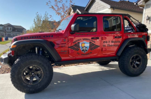 Rocky Mountain IV Medics red Jeep in Colorado side profile