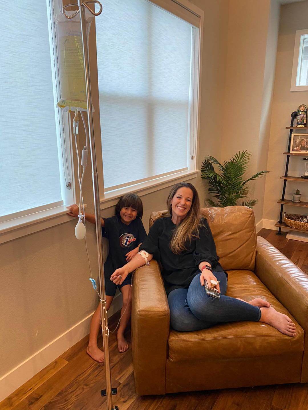 A mother gets IV Therapy in her home with her son