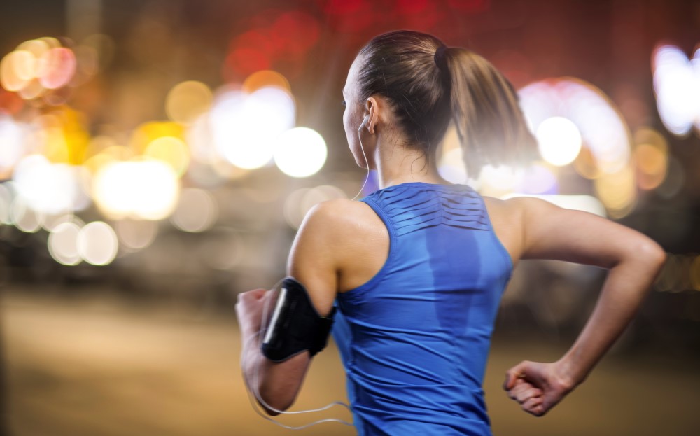 woman jogging at night sweating